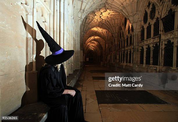 Harry Potter fan dressed in character costume poses sits in the cloisters as he waits to see the film Harry Potter and the Half-Blood Prince on a...