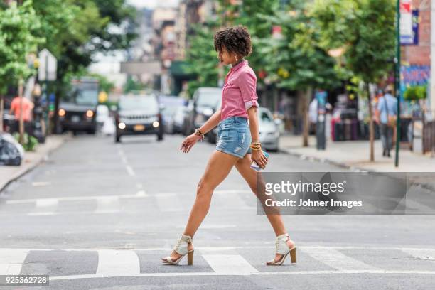 stylish woman walking on street - high heels stock pictures, royalty-free photos & images