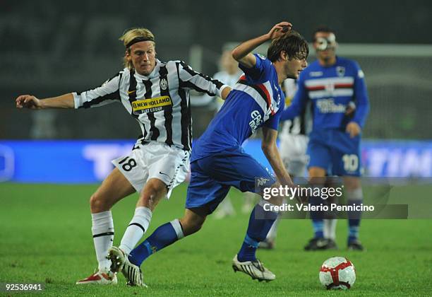 Christian Poulsen of Juventus FC competes for the ball with Andrea Poli of UC Sampdoria during the Serie A match between Juventus FC and UC Sampdoria...