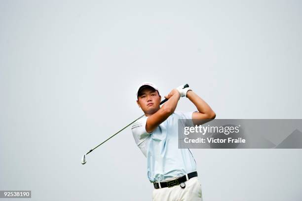 Mu Hu of China plays a shot during the day two of Asian Amateur Championship at the Mission Hills Golf Club on October 30, 2009 in Shenzhen,...