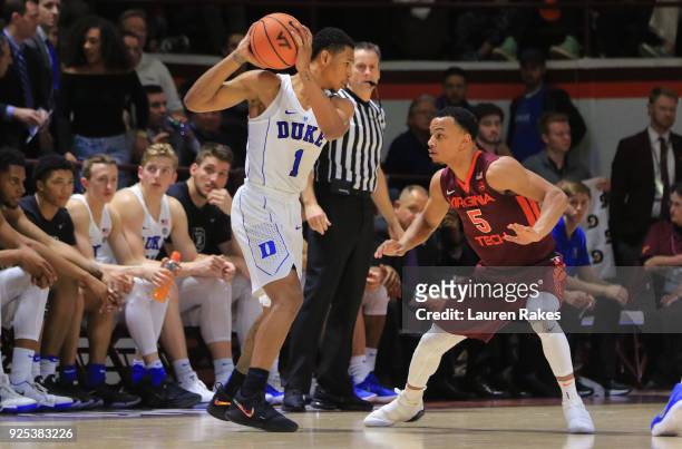 Trevon Duval of the Duke Blue Devils looks to pass while being defended by Justin Robinson of the Virginia Tech Hokies during the game at Cassell...