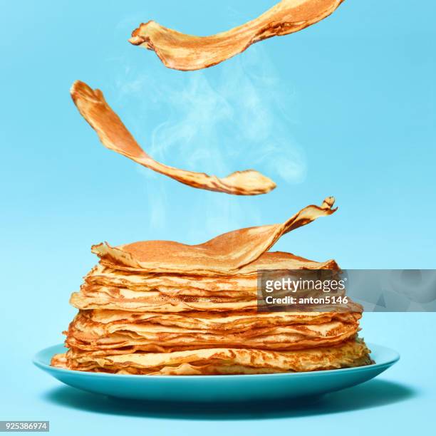 french pancakes is flying on the blue background - heap stock pictures, royalty-free photos & images