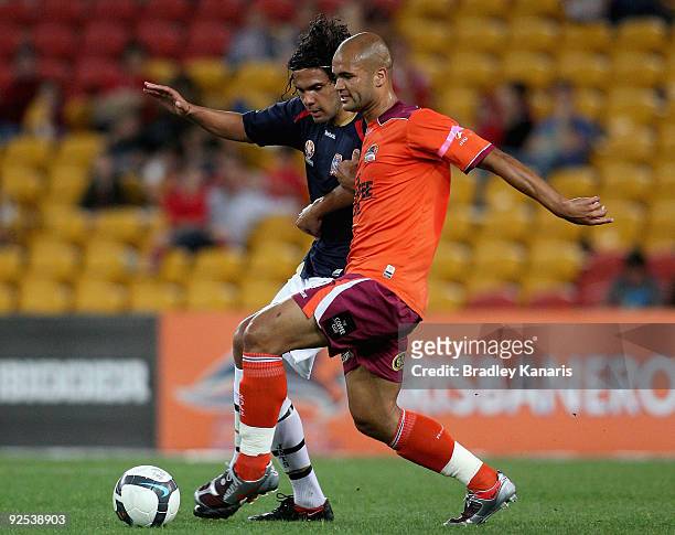 Sergio Van Dijk of the Roar and Nikolai Topor-Stanley of the Jets compete for the ball during the round 13 A-League match between the Brisbane Roar...