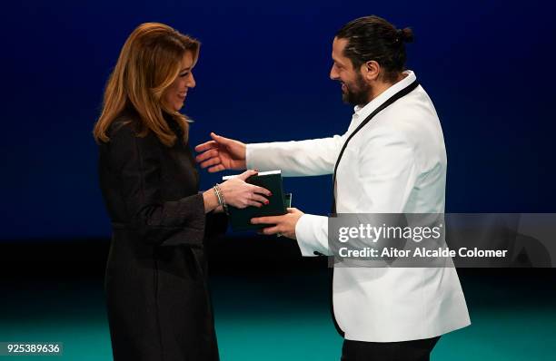 Spanish dancer Rafael Amargo receives the medal from President of Andalusia Susana Diaz during the Medal of Andalucia awards 2018 at the Teatro la...