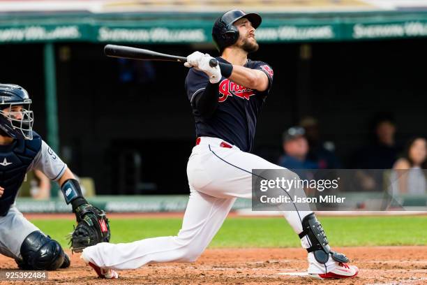 Lonnie Chisenhall of the Cleveland Indians hits an RBI sacrifice fly during the third inning against the San Diego Padres at Progressive Field on...