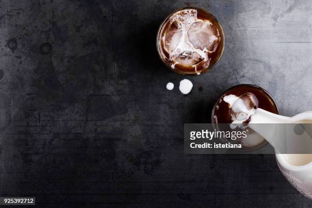 making thai iced coffee with cream - rustic cocktails stock-fotos und bilder