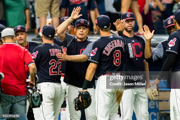 Bench coach Brad Mills celebrates with Lonnie Chisenhall and Erik Gonzalez of the Cleveland Indians after the Indians defeated the San Diego Padres...