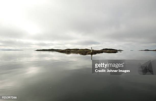 small island reflecting in sea - kattegat stock pictures, royalty-free photos & images