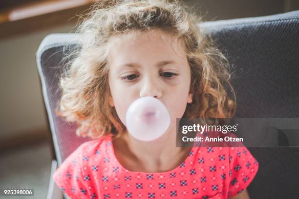 girl blowing bubble gum bubbles - bubble gum kid stock pictures, royalty-free photos & images