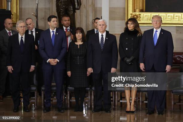 President Donald Trump and first lady Melania Trump present a wreath at Christian evangelist and Southern Baptist minister Billy Graham's casket as...