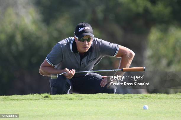 Henrik Stenson of Sweden lines up a putt on the 18th green during Day Two of the Group Stage of the Volvo World Match Play Championship at Finca...