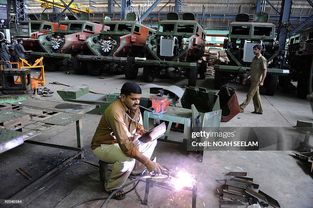 Indian factory workers makes parts for t
