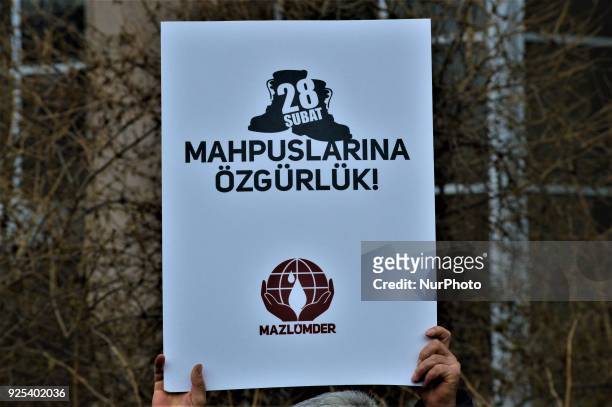 Man holds up a placard as an organized group of pro-Islamic demonstrators makes a statement outside the main courthouse on the 21th anniversary of...