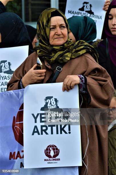 An elderly woman holds a placard as an organized group of pro-Islamic demonstrators makes a statement outside the main courthouse on the 21th...
