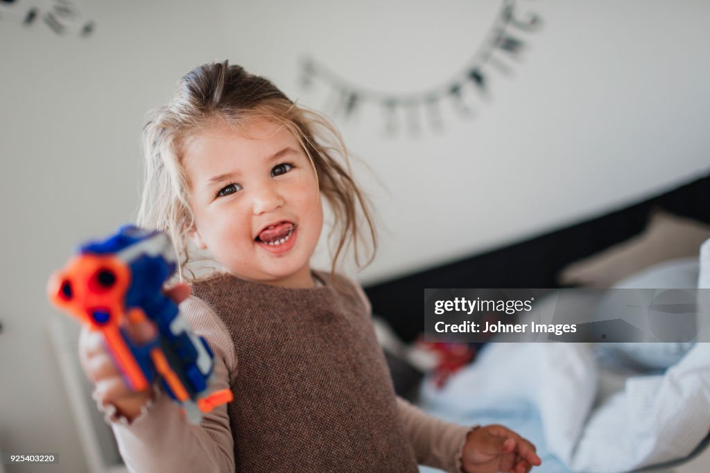 Cut girl playing with toys