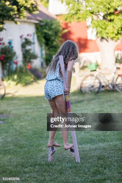 girl walking on stilts - styltor bildbanksfoton och bilder