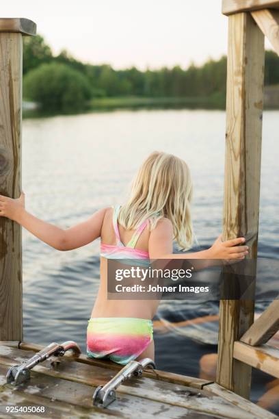 girl on jetty - bathing jetty stock pictures, royalty-free photos & images