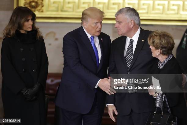 President Donald Trump and first lady Melania Trump greet Christian evangelist and Southern Baptist minister Billy Graham's family members as he lies...