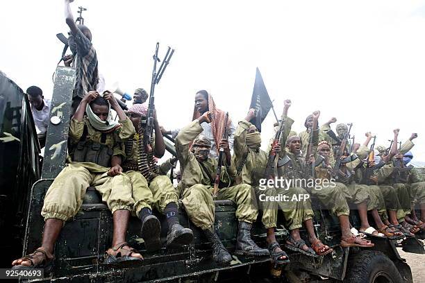 Hardline Islamist fighters from Al-Shabab chant slogans as they rally in the streets of Mogadishu on October 30, 2009 to show their support for...