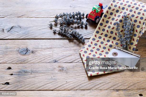 father's day concept. necktie with bouquet of lavender held with silver tie pin, blank greeting card for message and toy car on rustic wooden background. selective focus and copy space. - tie pin stock-fotos und bilder