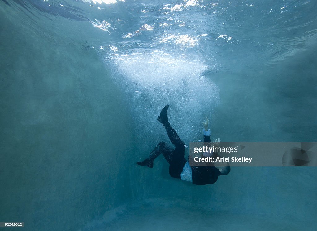 Businessman Falling Under Water