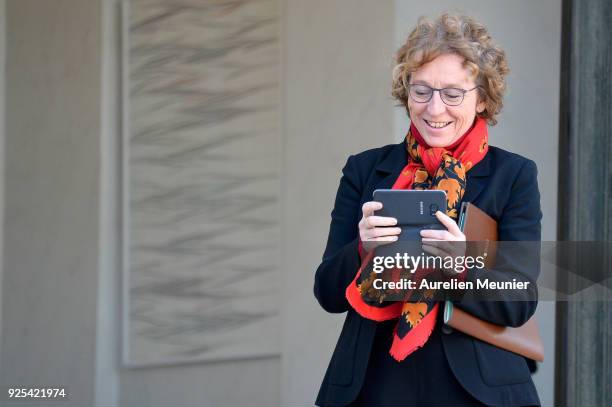 French Minister of Labor Muriel Penicaud takes a photo of the photographers as she leaves the Elysee Palace after the weekly cabinet meeting on...