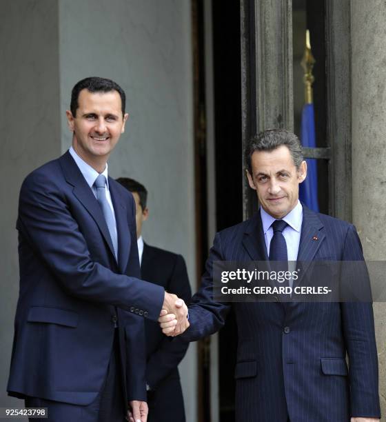 French President Nicolas Sarkozy welcomes Syrian President Bashar al-Assad prior to a meeting at the Elysee palace on July 12, 2008 in Paris, on the...