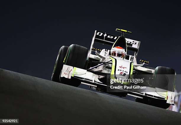 Rubens Barrichello of Brazil and Brawn GP exits the pitlane at dusk during practice for the Abu Dhabi Formula One Grand Prix at the Yas Marina...