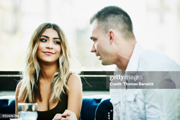 man and woman in discussion while sharing drinks in bar - hemd aufreißen stock-fotos und bilder