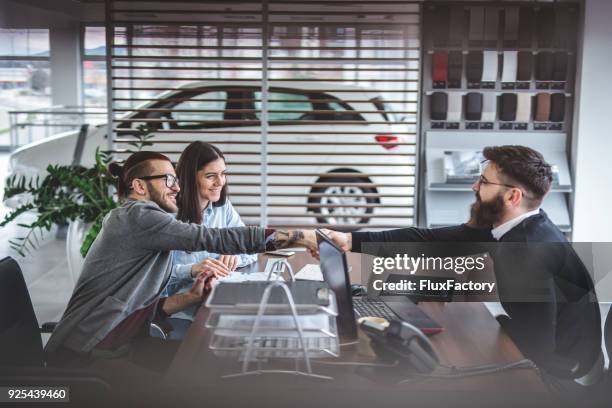 visiting the car dealership - car dealership stock pictures, royalty-free photos & images