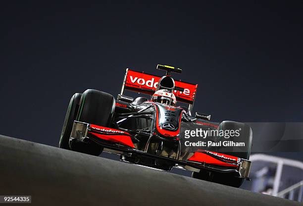 Heikki Kovalainen of Finland and McLaren Mercedes drives at night during practice for the Abu Dhabi Formula One Grand Prix at the Yas Marina Circuit...