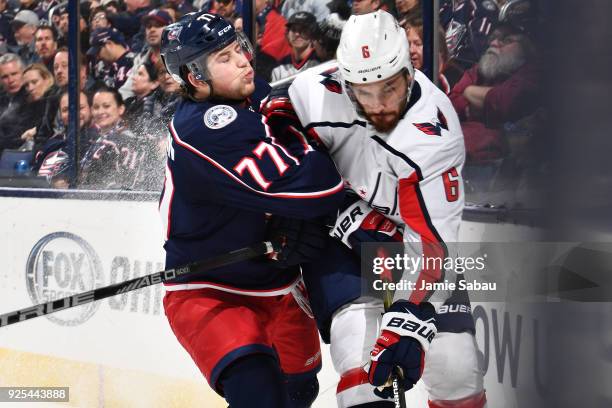 Josh Anderson of the Columbus Blue Jackets checks Michal Kempny of the Washington Capitals on February 26, 2018 at Nationwide Arena in Columbus, Ohio.