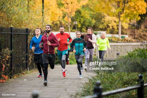 group of friends running together a - gender identity stock pictures, royalty-free photos & images