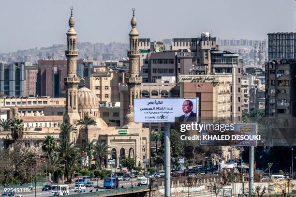 Picture taken on February 28, 2018 shows a billboard with an election poster for Egyptian President Abdelfattah al-Sisi standing next to a bridge...