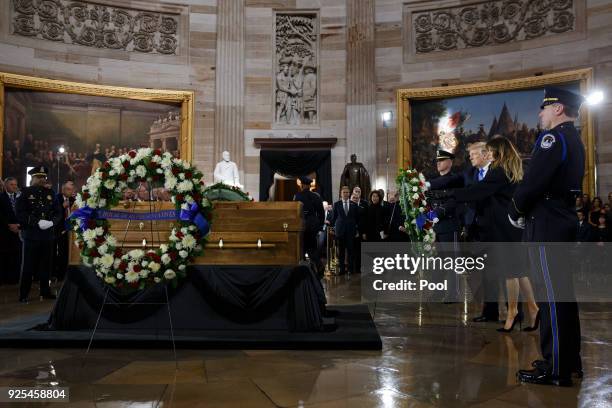President Donald Trump and first lady Melania Trump lay a wreath during a ceremony as the late evangelist Billy Graham lies in repose at the U.S....