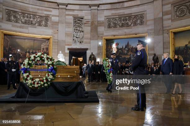 President Donald Trump and first lady Melania Trump lay a wreath during a ceremony as the late evangelist Billy Graham lies in repose at the U.S....