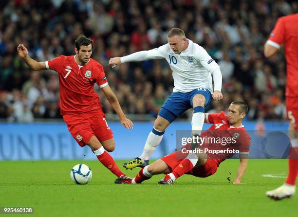Left to right: Joe Ledley of Wales, Wayne Rooney of England and Andrew Crofts of Wales in action during the UEFA EURO 2012 group G qualifying match...