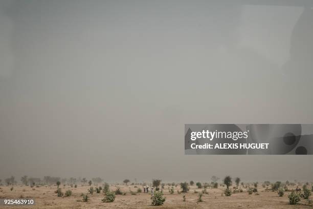 Children carry bags in a sand storm between Maroua and Mokolo, Far-North Region, Cameroon. Since 2014, the Far North region of Cameroon has witnessed...