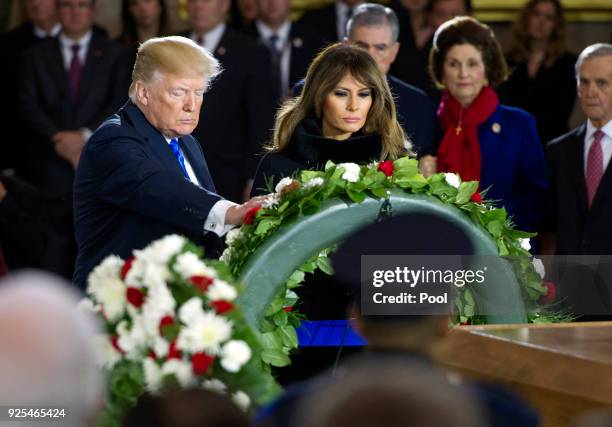 President Donald Trump and first lady Melania Trump lay a wreath during the ceremonies as the late evangelist Billy Graham lies in repose at the U.S....