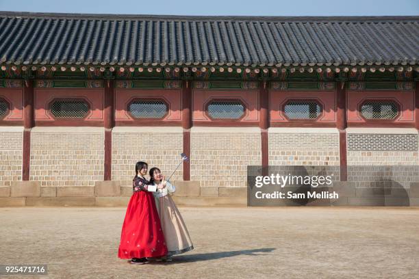 Young Koreans in Hanbok's, traditional Korean dress, pose for photos at the Gyeongbokgung Palace on 26th February 2018 in Seoul, South Korea....