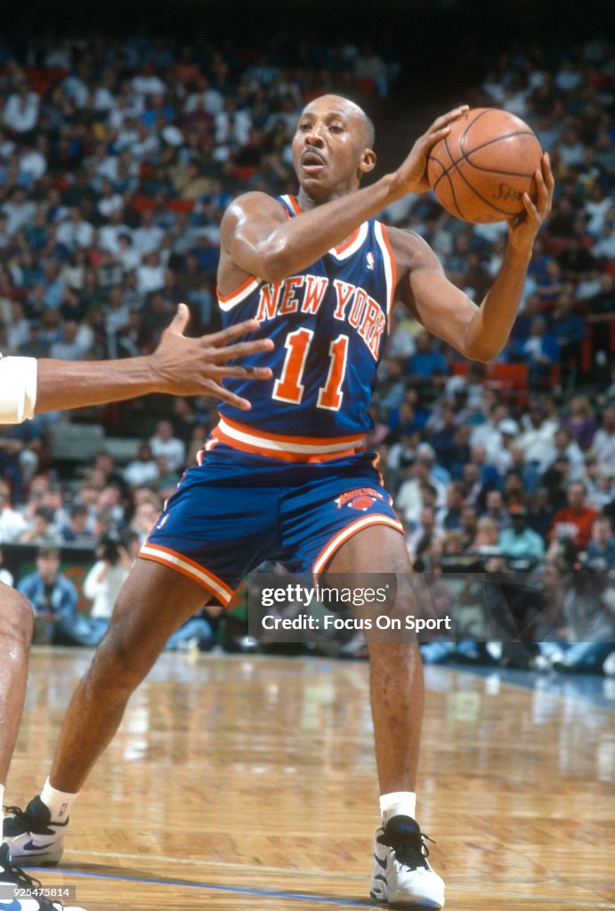 Derek Harper of the New York Knicks looks to pass the ball against ...
