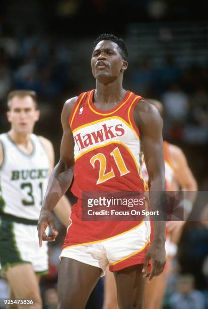 Dominique Wilkins of the Atlanta Hawks looks on against the Milwaukee Bucks during an NBA basketball game circa 1989 at the Bradley Center in...
