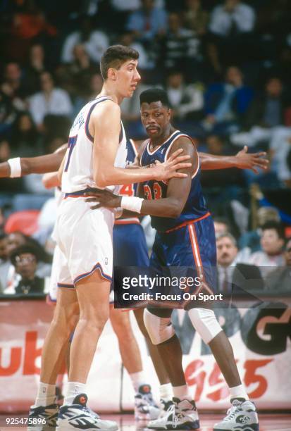 Gheorghe Muresan of the Washington Bullets works for position on Patrick Ewing of the New York Knicks during an NBA basketball game circa 1994 at the...