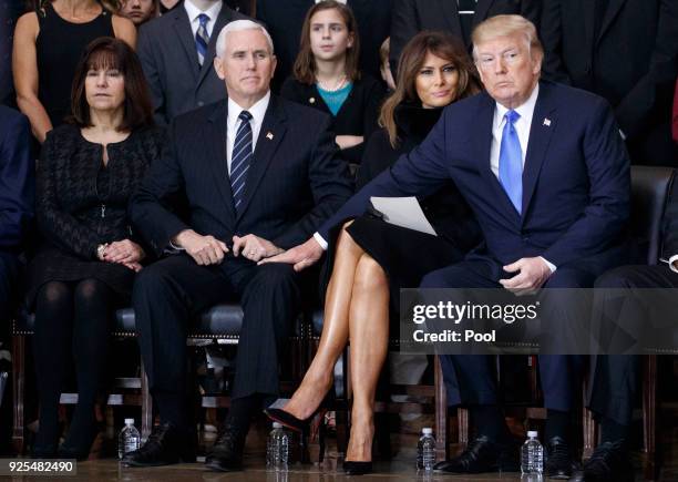 Second lady Karen Pence, U.S. Vice President Mike Pence, first lady Melania Trump and President Donald Trump attend the cermonies as the late...