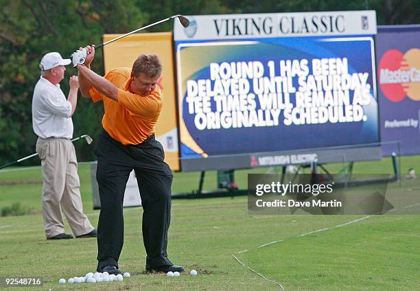 Mark Brooks and Billy Mayfair work out on the driving range after first round play was postponed in the Viking Classic at the Annandale Golf Club on...