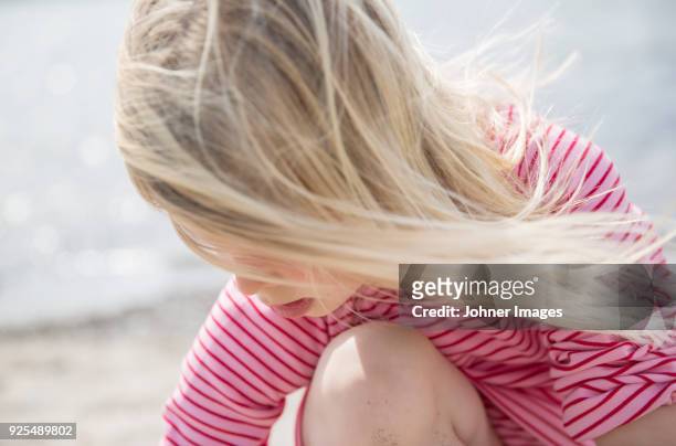 girl looking down - girl blowing sand stock-fotos und bilder