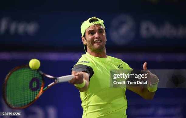 Malek Jaziri of Tunisia plays a forehand during his match against Robin Haase of Netherlands on day three of the ATP Dubai Duty Free Tennis...