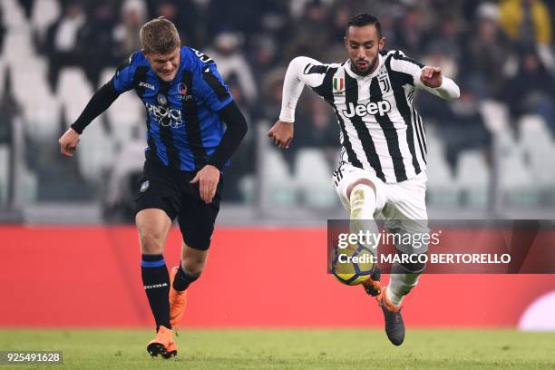 Atalanta's defender Timothy Castagne from Belgium fights for the ball with Juventus' defender Medhi Amine Benatia from Morocco during the Italian Tim...