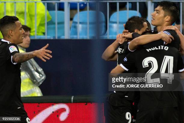 Sevilla's Argentinian midfielder Joaquin Correa celebrates a goal with teammates during the Spanish league football match Malaga CF against Sevilla...