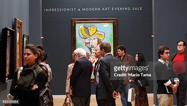 People look at artwork during a preview of Sotheby's fall Evening Sale of Impressionist and Modern Art October 30, 2009 in New York City. The...